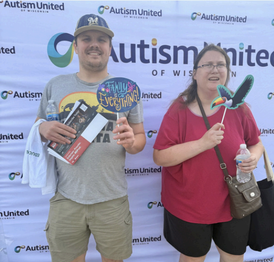 Autism United event participants holding prizes
